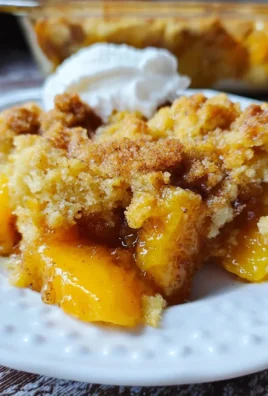 Delicious peach cobbler made with cake mix, served in a baking dish.