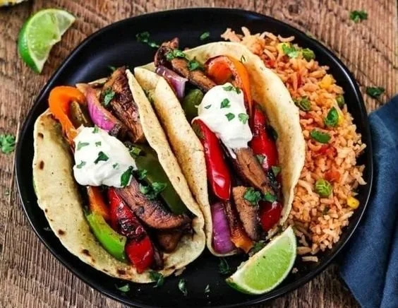Portobello vegan fajitas served with colorful peppers and onions