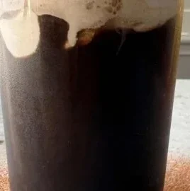 Delicious Tiramisu Cold Brew served in a glass with chocolate and coffee layers