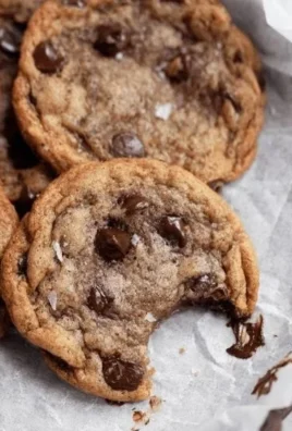 Freshly baked Banana Chocolate Chip Cookies on a cooling rack