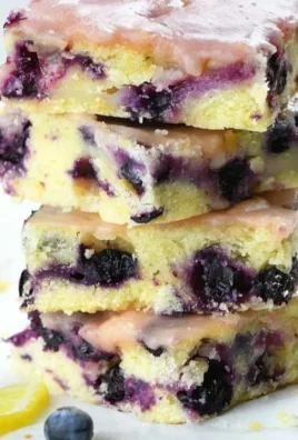 Freshly baked Blueberry Lemon Blondies with blueberries and lemon zest
