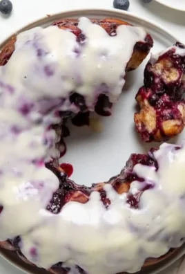 Freshly baked blueberry monkey bread with gooey sauce and blueberries