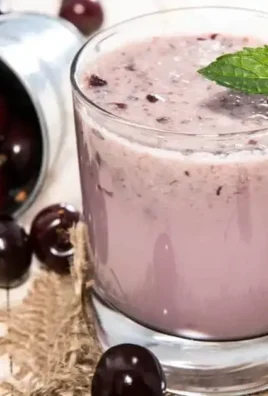 A delicious Cherry Vanilla Smoothie topped with cherries and whipped cream.