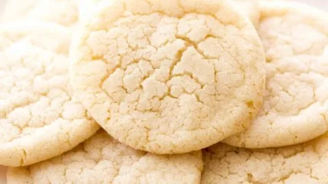 Chewy sugar cookies on a cooling rack, golden brown and appetizing.