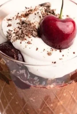 Bowl of chocolate cherry overnight oats topped with fresh cherries and chocolate chips.
