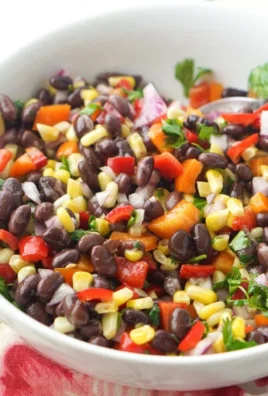 Bowl of colorful Mexican Bean Salad with beans, vegetables, and lime dressing.