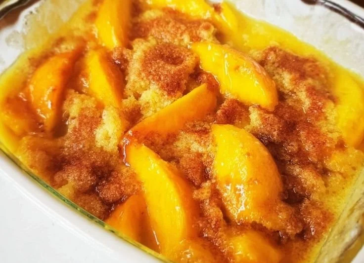 Homemade easy peach cobbler with fresh peaches served in a baking dish