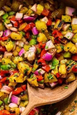Delicious Grilled Pineapple Salsa served in a bowl with fresh herbs.