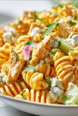 High Protein Buffalo Chicken Pasta Salad in a bowl with vegetables and dressing