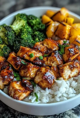 Delicious hot honey chicken bowls recipe with colorful vegetables and rice.