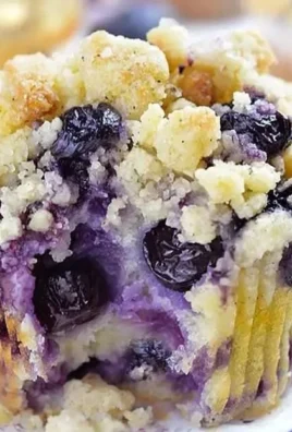 Freshly baked lemon blueberry muffins on a cooling rack