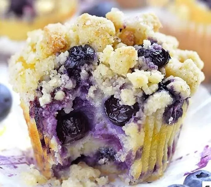 Freshly baked lemon blueberry muffins on a cooling rack