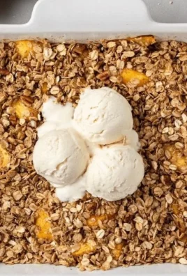 Delicious homemade Peach Crisp with a golden topping and fresh peaches